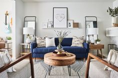 a living room filled with furniture and pictures on the wall above it's fireplace