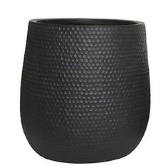 a large black vase sitting on top of a table