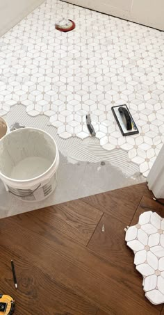 a bathroom floor that is being remodeled with tools on the ground and in front of it