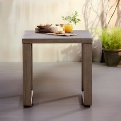 a wooden table with plates and cups on it