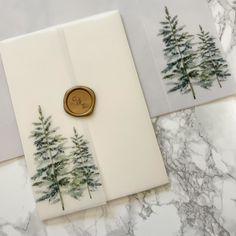 two cards with trees on them and a wax stamp