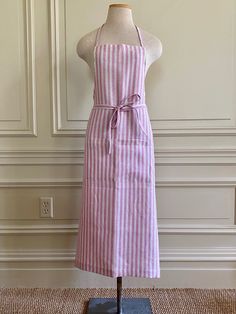 a mannequin wearing a pink and white striped apron