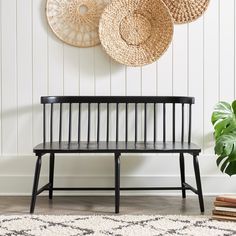 a wooden bench sitting in front of two baskets on the wall