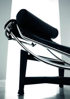 a black and white photo of a modern chair