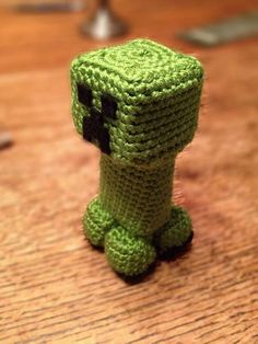 a crocheted toy sitting on top of a wooden table