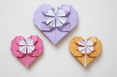 three origami hearts with the text diy a sweet origami heart perfect to give to a loved one on valentine's day visit the blog