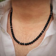 This striking men's beaded necklace combines vintage Boho with contemporary style. It is a classic strand of Grade A jet-black Agate and Grade A Onyx gemstone beads in matt and high gloss finishes with silver-tone metal spacers. It is also available with an optional 1 cm x 2 cm Egyptian Ankh pendant. This ancient Egyptian hieroglyph means 'life' or 'breath of life' and was used in many ancient rituals by gods and pharaohs. Available in four sizes - 18, 20, 22 or 24 inches. Model wears 22".  I al Egyptian Hieroglyph, Ancient Rituals, Ankh Pendant, Egyptian Ankh, Jewellery For Men, Silver Beaded Necklace, Silver Bead Necklace, Black Bead Necklace, Long Beaded Necklace