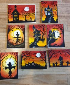 painted halloween cards on a wooden table