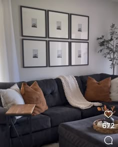 a living room filled with furniture and pictures on the wall above it's coffee table