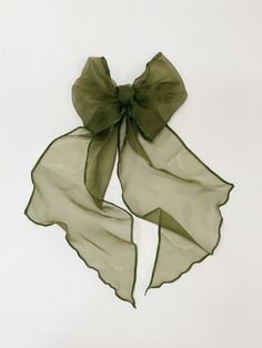 a green scarf with a bow on it