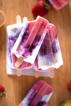 popsicles with blueberries and strawberries on them