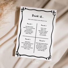 a drink list sitting on top of a bed next to an animal's fur