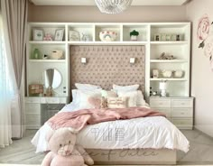 a bedroom with a bed, dressers and a pink teddy bear on the floor