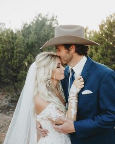 the bride and groom are embracing each other