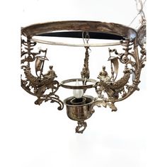 an ornate chandelier hanging from the ceiling with two candles in it and birds on top