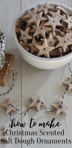 a white bowl filled with star shaped christmas ornaments next to a string of twine