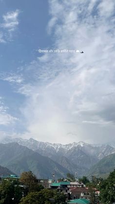 an airplane is flying over the mountains in the sky with snow on it's tops