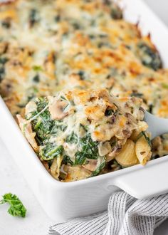 a casserole dish with spinach and cheese