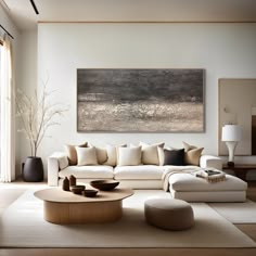 a living room filled with furniture and a painting on the wall