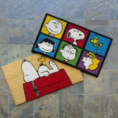 two rugs with cartoon characters on them sitting on the floor next to each other