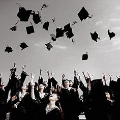 a group of graduates throwing their caps in the air with graduation hats thrown above them