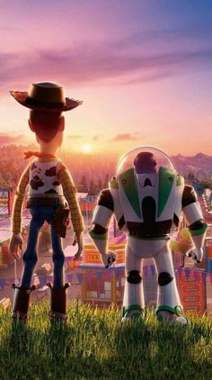 two toy story characters standing in front of a carnival park at sunset with the sun setting behind them