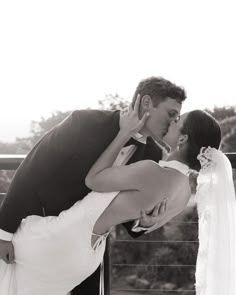 a bride and groom kissing on their wedding day