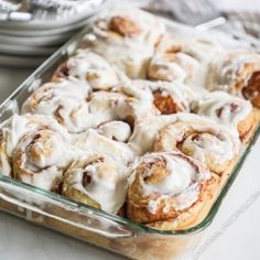 a glass baking dish filled with cinnamon rolls