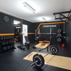 a home gym with black walls and yellow trimmings on the wall is shown