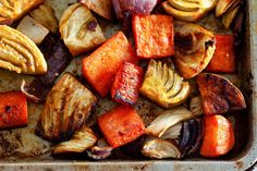 roasted vegetables in a baking dish on a sheet metal pan, ready to be cooked