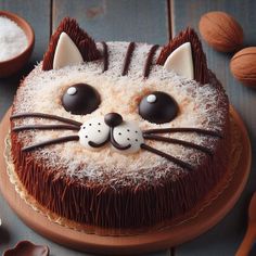 a cake decorated to look like a cat with chocolate eyes and whiskers around it