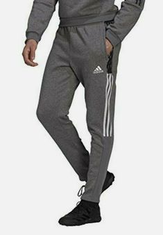 Adidas Men Tiro 21 Sweat Pants Grey  (GP8802) TAPERED SWEAT PANTS FOR OFF-PITCH COMFORT. Relax, regroup, recover. These adidas sweat pants are ideal for the quieter moments of soccer, like stretching before a match or heading home when training is over. The cotton-blend fleece feels soft and cozy. Zip pockets keep essentials close. This product is made with recycled content as part of our ambition to end plastic waste. WASHING INSTRUCTIONS Do not bleach Tumble dry low heat Do not dry clean Touch Adidas Sportswear Sweatpants For Workout, Adidas Moisture-wicking Sweatpants For Jogging, Training Sweatpants With Pockets, Adidas Joggers For Sports, Adidas Sportswear Pants With Moisture-wicking, Adidas Athleisure Jogging Pants, Adidas Moisture-wicking Sportswear Pants, Adidas Gym Pants With Three Stripes, Adidas Cotton Sportswear Joggers