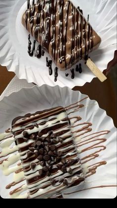 two paper plates topped with desserts on top of each other and covered in chocolate