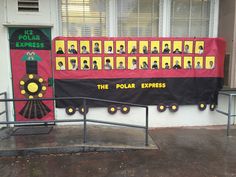 the polar express train is on display in front of a building with windows and doors