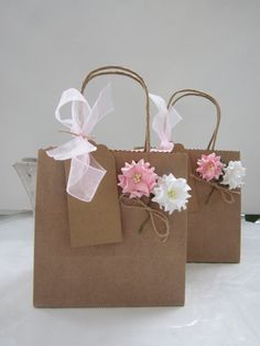 three brown bags with pink and white flowers on them