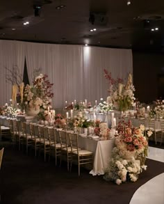 a banquet table set up with flowers and candles