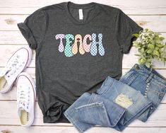 a t - shirt with the word taco on it next to jeans and sneakers