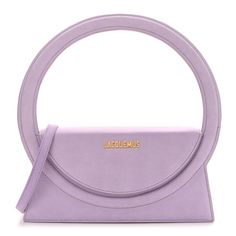 This is an authentic JACQUEMUS Nubuck Le Sac Rond in Lilac. This stylish bag is crafted of smooth calfskin leather in light purple. The bag features a large top handle, an optional leather shoulder strap, and gold hardware. The front flap opens to a beige fabric interior with a pocket. Circle Bag, Beige Fabric, Painting Edges, Stylish Bag, Metallic Logo, Light Purple, Gold Hardware, Water Repellent, Top Handle