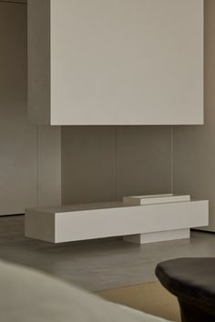 a modern living room with white furniture and large wall mounted speaker system in the center