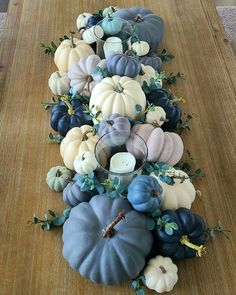 a table topped with blue and white pumpkins