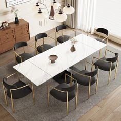 a dining room table with black chairs and a white marble top