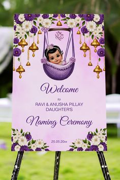 a welcome sign for a baby girl in a swing with bells and flowers on it