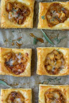 four square pastries topped with mushrooms and herbs