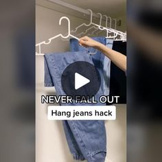 someone is trying to hang jeans in the closet and it's not too easy