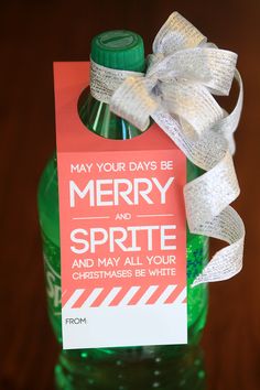 a bottle with a label on it and a ribbon tied around the top that says merry and sprite and may all your christmas be white