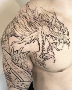 a man's chest with a dragon tattoo on it