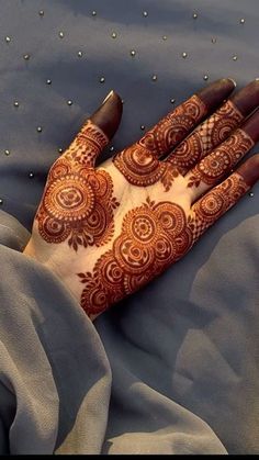 a henna on someone's hand that is laying down