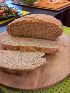 sliced loaf of bread sitting on top of a wooden cutting board