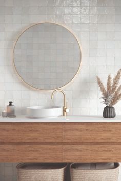 a bathroom vanity with two round mirrors above it