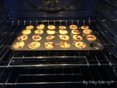 an open oven with muffins baking in it